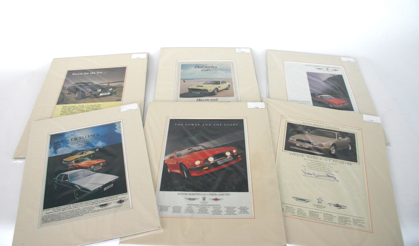 A collection of original Aston Martin mounted adverts set 2 (1 of 7)