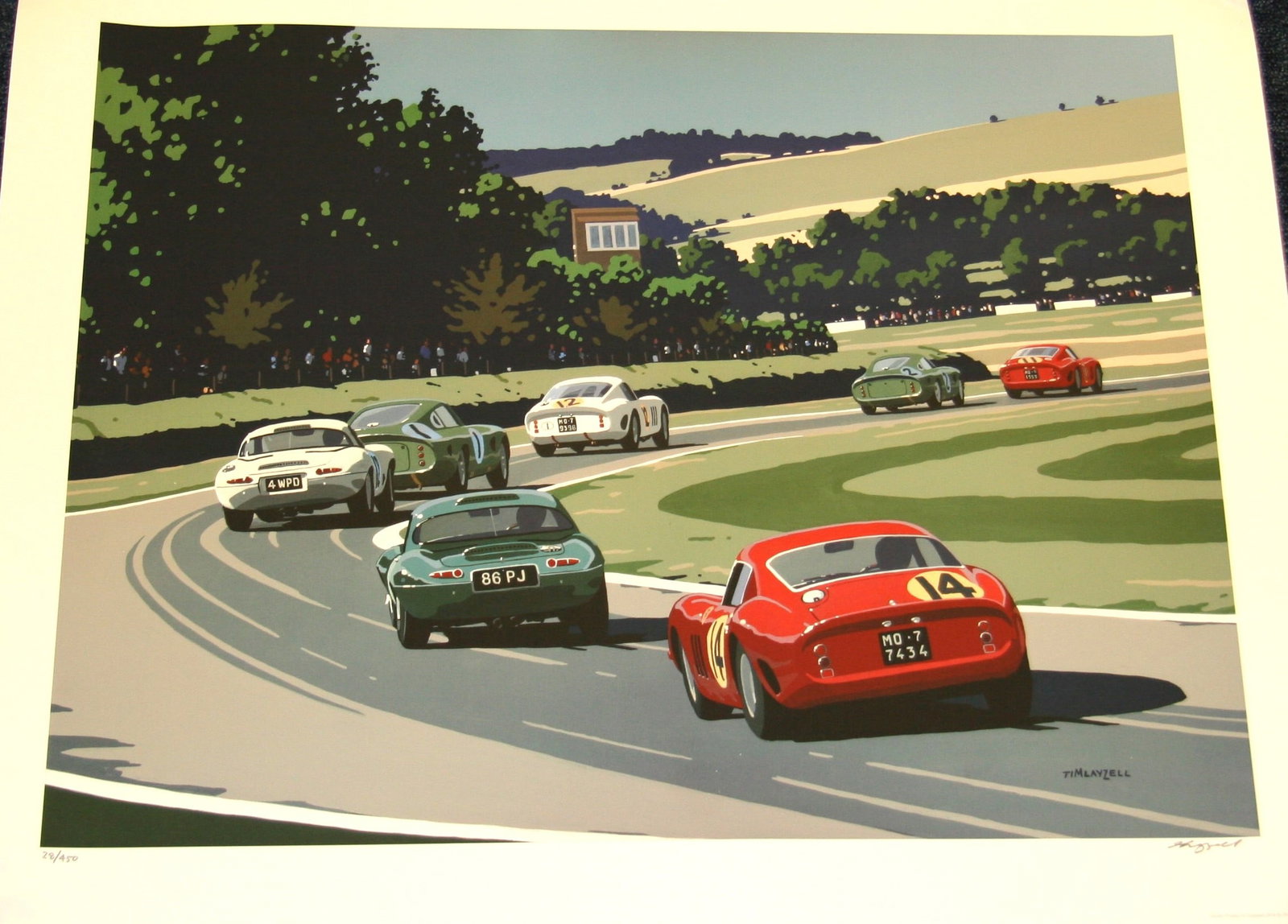 Original Tim Layzell limited edition Goodwood TT print: An original Tim Layzell print number 28/250 depicting cars racing at the TT Celebration at Goodwood. Mint condition, rolled. Measures 77cm x 60cm. 