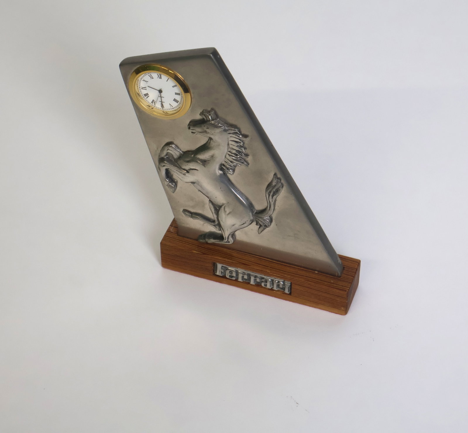 Ferrari desk clock: A metal Ferrari desktop ornament on a wooden plinth. Excellent condition.