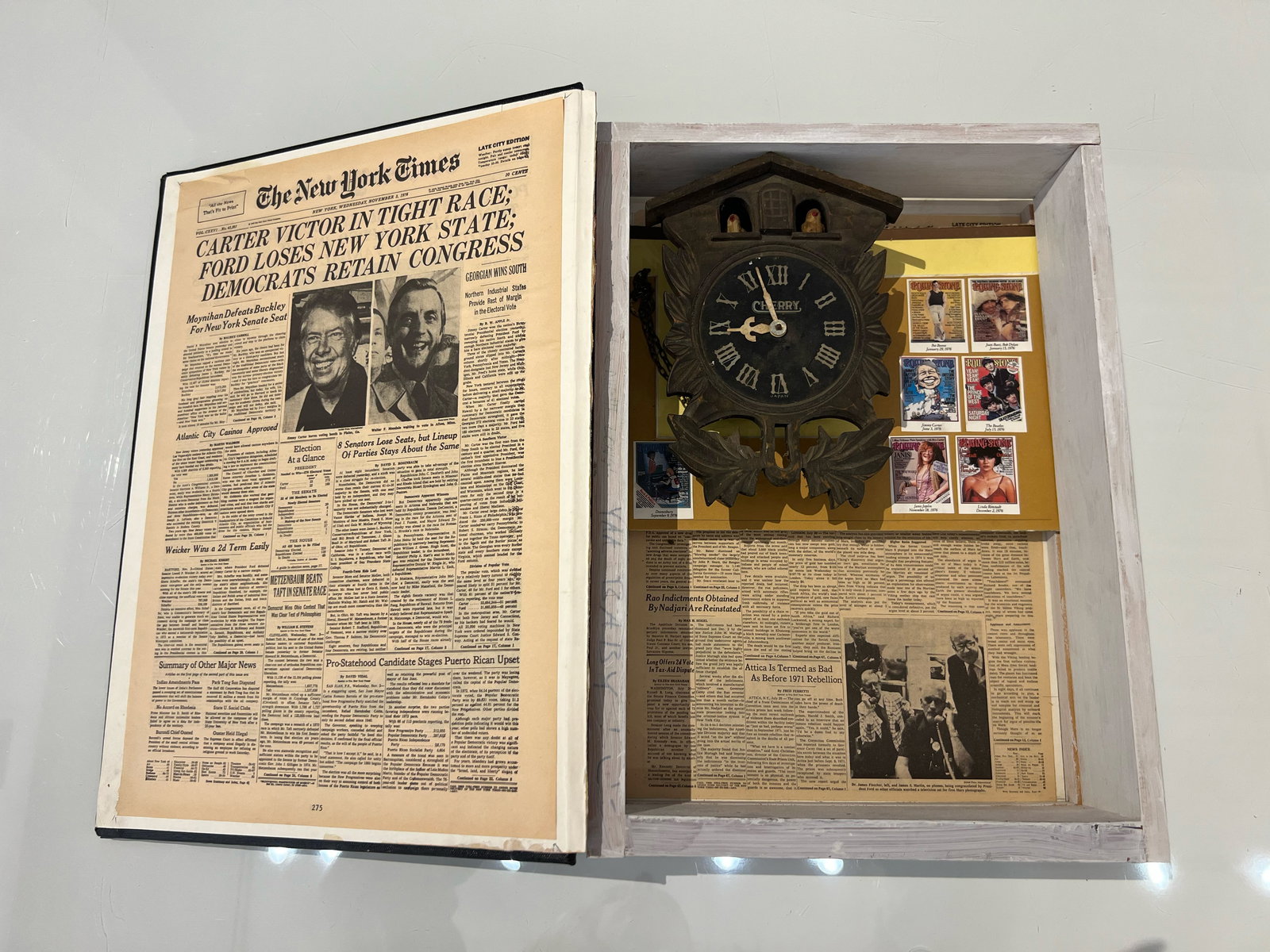 Dave Stewart "Cuckoo Clock Book": c. 1970, Multimedia sculpture. Multimedia sculpture including wood, book, cuckoo clock, newspaper. Directly from the artist. Closed: 16 x 11.5 x 3.5 inches Opened: 16 x 22 x 3.5 inches