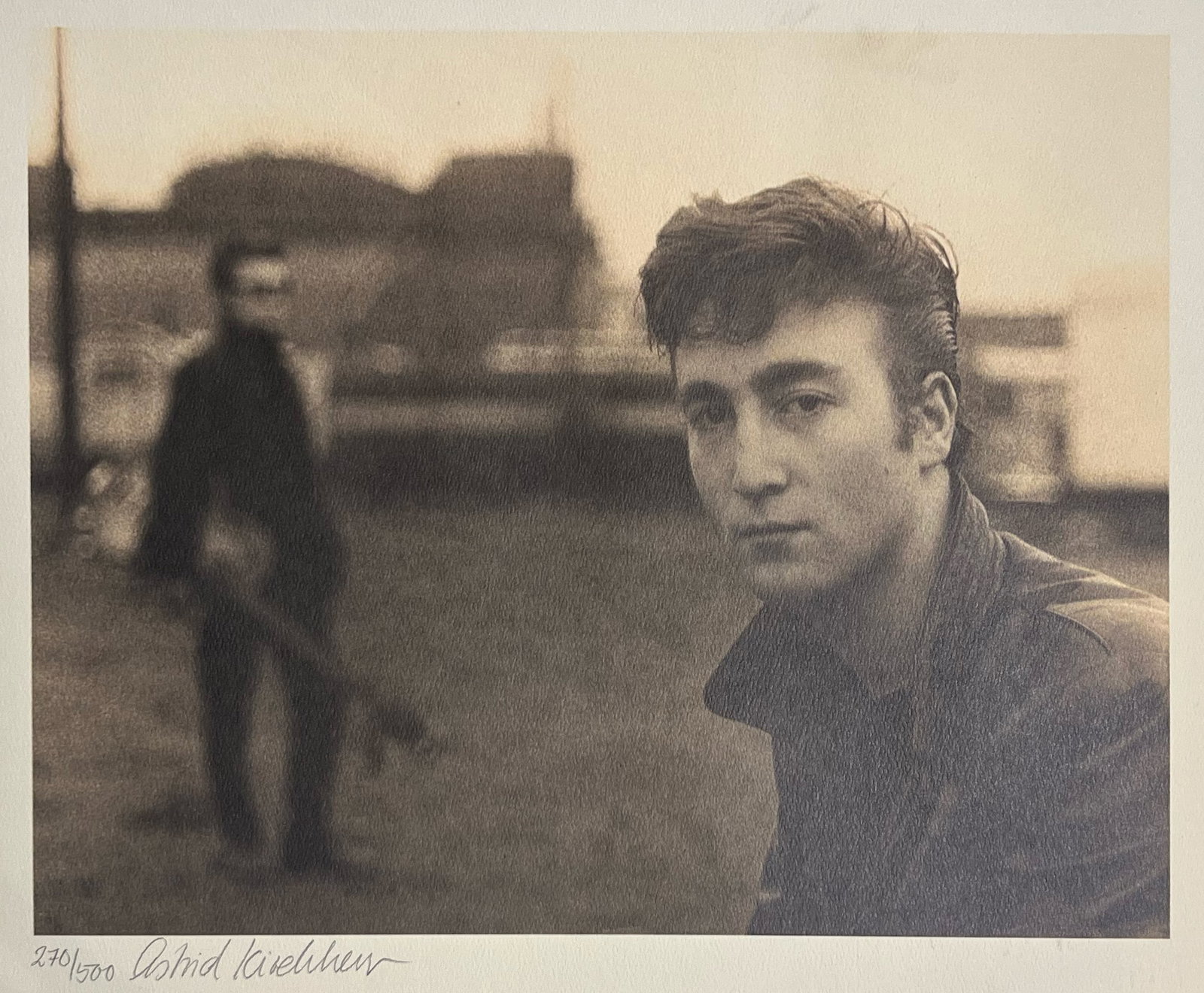 Astridd Kirchherr "John Lennon, Funfair Portrait, Hamburg, 1960": Edition 270/500. Lithograph of John Lennon. Plate: 12.25 x 15.5 inches. Sheet: 16.5 x 23.5 inches. Signed lower right.