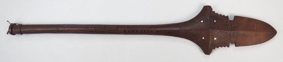 A FIJIAN CULACULA WARCLUB: Of characteristic form, dark hardwood with complex geometrical carving and inlaid mother of pearl plaques. Mid-20th century. Overall length 110.8 cm. Condition II