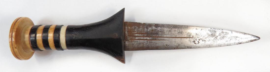 A SUDANESE ARM DAGGER: With ebony and elephant grip and broad, fullered blade. Latter 19th century. Minor wear. Overall length 21 cm. Condition III