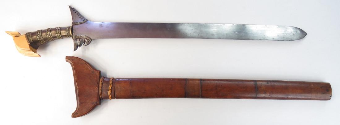 A MORO DATUS KRIS SWORD: Likely Maguindanao work, the elaborately-worked junggayan hilt typically carried by a datu or noble, with elephant kakatua-form pommel and silver mounts in bands of fine filigree. Engraved silver baca