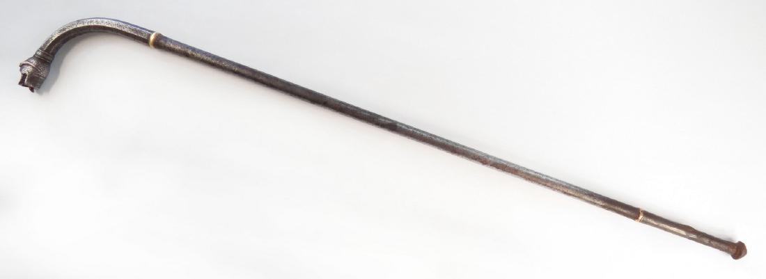 AN INDIAN SOTA MACE: A rare type, wrought entirely of steel, the cylindrical haft with lightly tapering grip and knob pommel, the curved section chiseled in a geometrical lineal motifs representing tiger stripes. The head