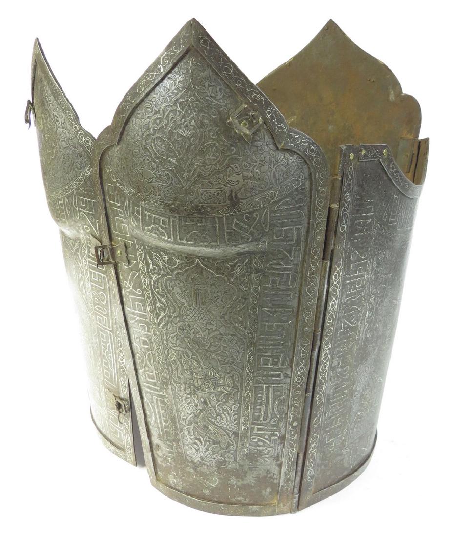A RARE PERSIAN CUIRASS ARMOR: Qajar era, very rarely encountered. Wrought of five plates, each cusped at the upper extremity, with hinged edges, the front plates with buckles. Elaborately etched overall with Persian heroes amongst