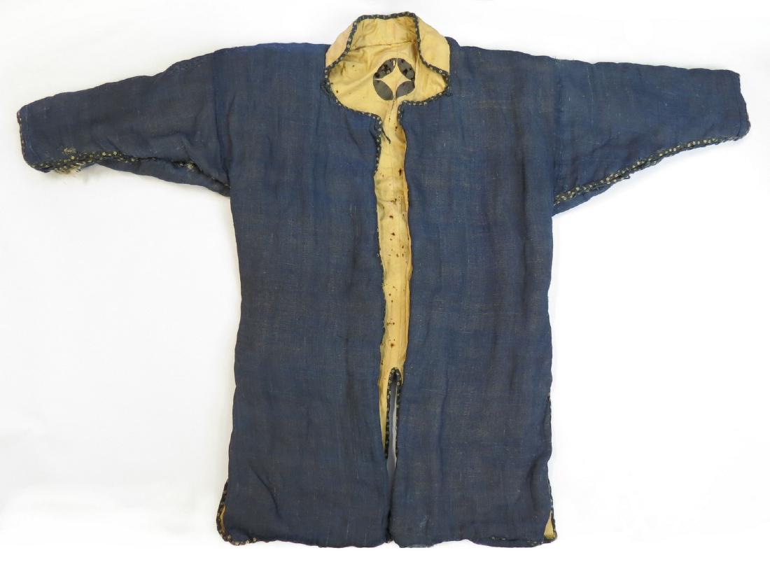 A JAPANESE KUSARI KATABIRA CONCEALED ARMOR: Rarely encountered, an Edo-era samurai garment of padded blue fabric, enclosing a full coat of mail, with high collar, lined in white fabric stamped with the Shippo Mon. Latter 17th century. Minor los