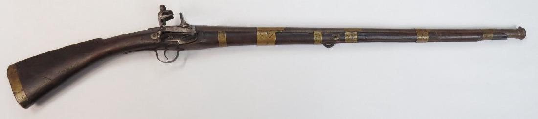 A BALKAN DZEFERDAR MUSKET: An unusually early example of the type, based upon an Italian longarm which evolved in Boka Kotorska. A massive example stocked in dark hardwood, with sloping butt. Mounted in brass, the early lock an