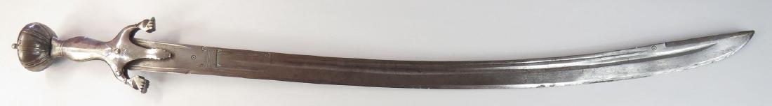 AN AFGHAN PULOWAR SWORD: The steel hilt of characteristic form, faceted and profiled. The robust blade fullered, with back edge and incised birds eye talismans. Early 19th century. Some wear. Overall length 90.5 cm. Condition