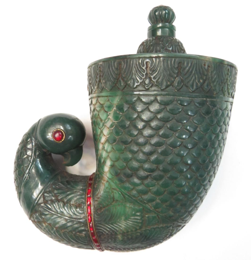 A RARE INDIAN STONE BARUTDAN POWDERHORN: A fine Mughal example, the body of green stone with touches of cream, superbly carved in an imbricated feather motif with broad acanthus borders, interspersed with bands of rectangular red cabochons i