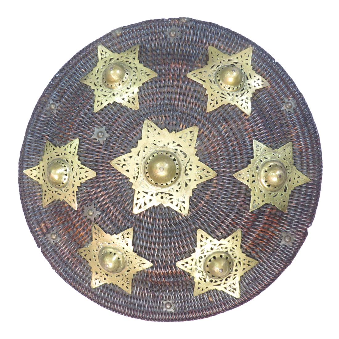 A RARE ACEHNESE PEURISE AWE SHIELD: A larger than average example of characteristic form, wrought entirely of plaited rattan with a domed center and flattened rim, with seven brass mounts in the form of the Seal of Solomon, pierced and 