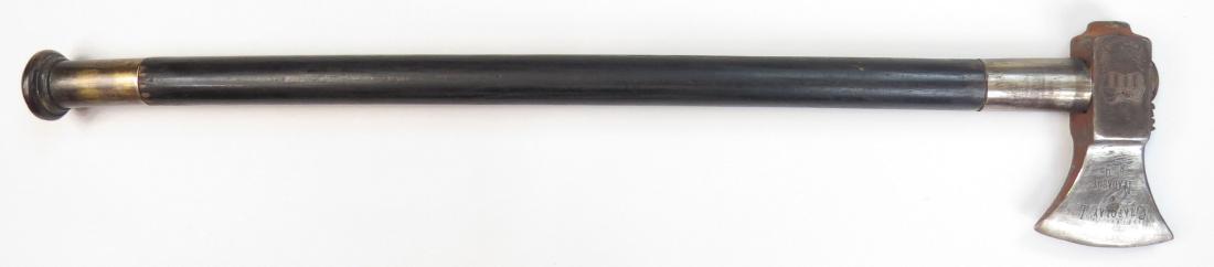 A HUNGARIAN FOKOS AXE: The polished steel head with inscriptions commemorating the Hungarian Uprising of 1848 . On its black-lacquered haft with polished mounts. Early 20th century. Worn. Overall length 62cm. Condition III