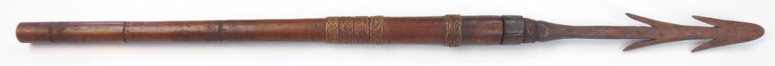 A PHILIPPINES FISHING SPEAR: Igorot People, the well-forged steel head with double barbs and chamfered edges, with expanded socket, retained with finely-woven bands of rattan and an iron ferrule. The hardwood haft well-balanced. 