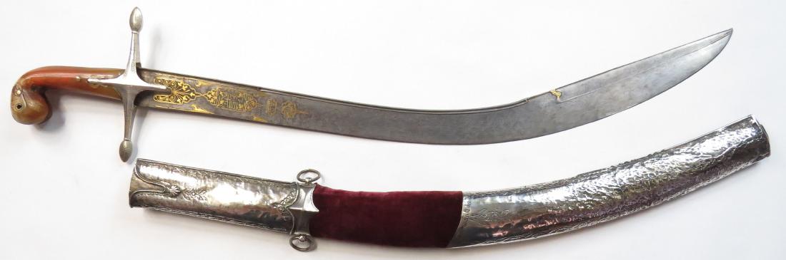 AN OTTOMAN PALA KILIC SWORD: A rare example of classic form, the hilt with fibrous horn grips and silvered guard, the mounts of silver elegantly engraved in Ottoman geometrical and vine motifs. The broad, T-section blade with fin