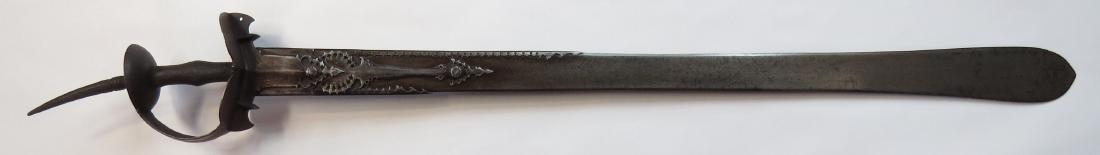 A FINE INDIAN KHANDA SWORD: A massive example, the steel hilt of characteristic basket-type wrought of steel with profiled borders and long spike pommel affording a two-handed grip. The long, robust blade with superbly fretted a