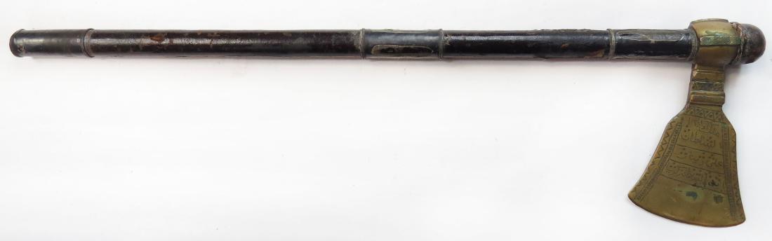 A BATTLE AXE OF SULTAN ALI DINAR OF DARFUR: The brass blade with stamped decoration and flanged bronze poll, inscribed on the right: MALIK AL SULTAN ALI DINAR IBN AL SULTAN ZAKARIA and on the left: SULTAN MOHAMMED AL-FAZAL [and] IBN ABD’ AL R