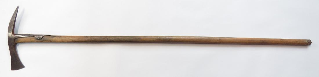 A HUNGARIAN FOKOS AXE: The blade with backspike, marked with a skull supported by a banner, likely carried by the famed 106th Assault Battalion during WWI. On its hardwood haft with steel reinforcement. Early 20th century. 