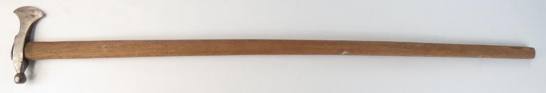 A HUNGARIAN FOKOS AXE: With steel head. On its long hardwood haft. 19th-20th century. Worn. Overall length 90.5cm. Condition III