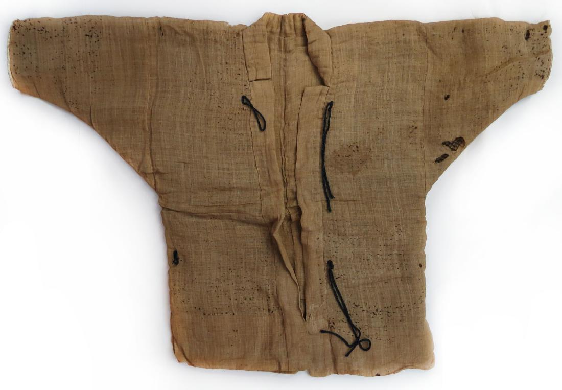 A JAPANESE KUSARI KATABIRA CONCEALED ARMOR: Rarely encountered, an Edo-era samurai garment of padded linen fabric, enclosing a full coat of mail, with high collar, and lined. Latter 17th century. Minor losses. Overall height 78cm. Condition III