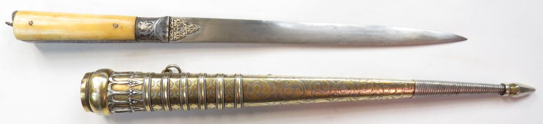 A RARE CENTRAL ASIAN KARD DAGGER: With well-formed bone grips, the pommel set with an Imperial Russian silver coin dated 1828, the tangband finely chiseled, the forte set with pierced and profiled gilded silver panels. The broad singl