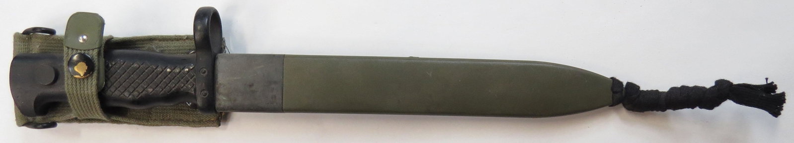 A SPANISH M 1964-69 BAYONET: Fits FR 7-8 rifle. In its sheath. Light wear. Overall length 37cm. Condition III