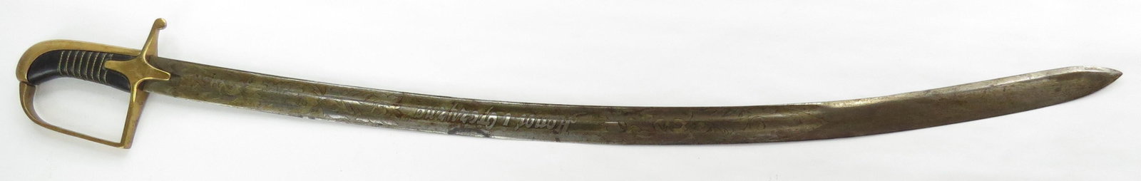 A POLISH M 1921 CAVALRY SABER: Of characteristic form, with brass hilt and leather-covered grip retaining twisted wire wrap. The lightly curved, fullered and spear tipped blade. First quarter of the 20th century or later. Light wea