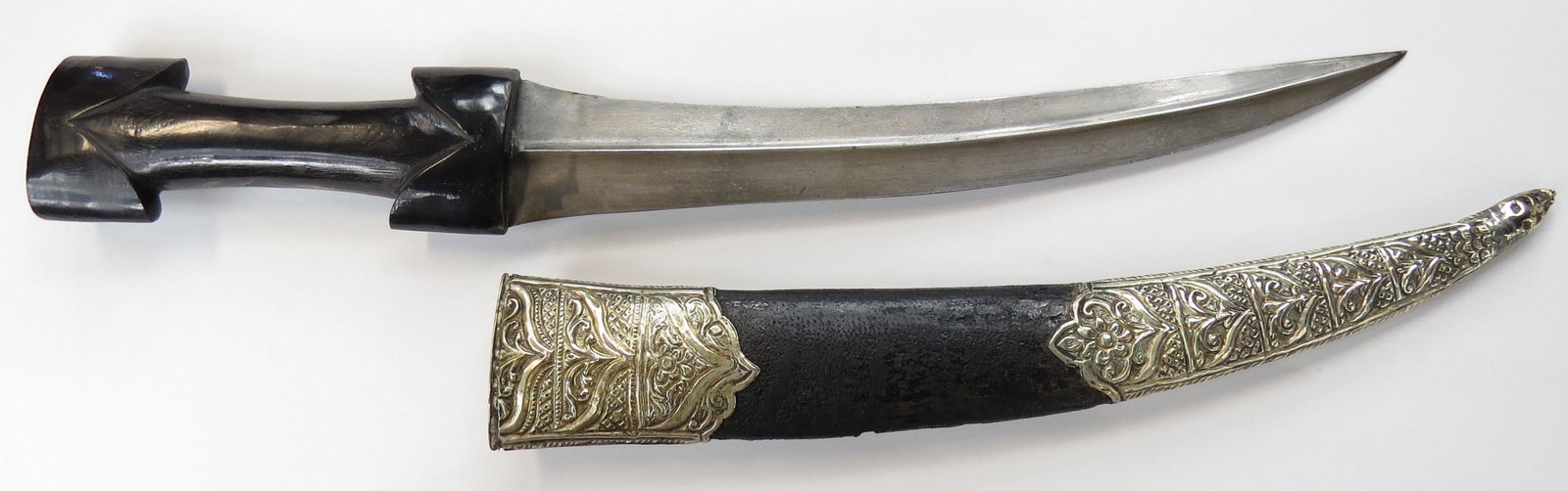 A RARE ALBANIAN KHANJAR DAGGER: The characteristic grip carved of a single large section of horn, the curved, double-edged blade with high central ridge wrought of fine, actively patterned wootz. In its leather-covered wooden scabba