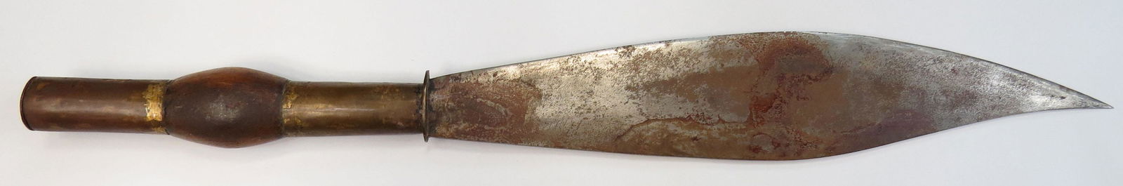 A PHILIPPINES SHORTSWORD: The broad, handforged blade with plug bayonet-style hilt of brass and hardwood. Late 19th-Early 20th century. Well worn. Overall length 45cm. Condition III