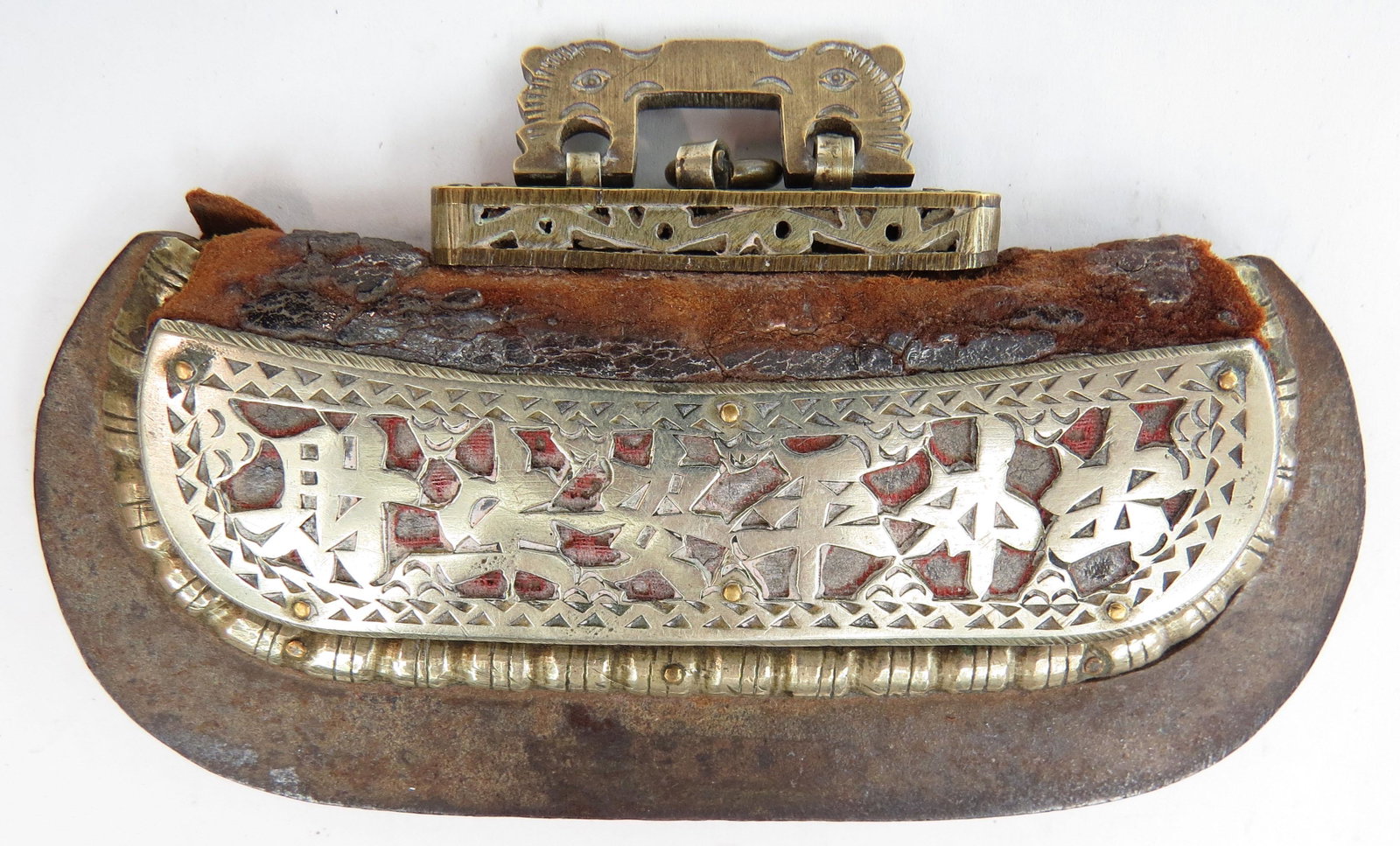 A CHINESE FLINT STRIKER: Mid-Qing Dynasty, composed of hide, steel and pierced and profiled brass, with silver appliques. First half of the 19th century. Minor wear. Overall length 10cm. Condition II