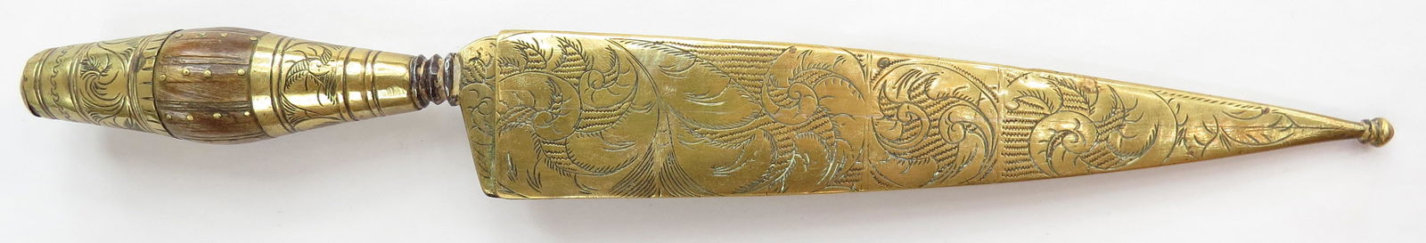 A MEDITERRANEAN DAGGER: Likely Spanish, the plug-form grip mounted in engraved brass with large bolster. Broad, single-edged engraved blade with substantial back edge, engraved and inlaid with brass. Brass sheath engraved en