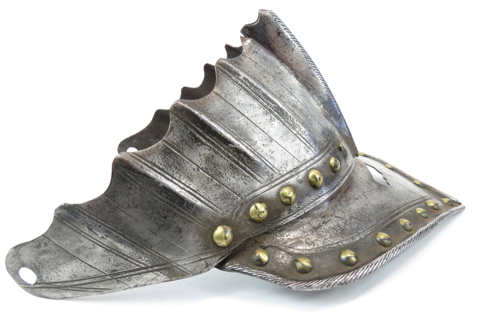 A RARE EUEOPEAN ARMOR ELEMENT VISOR: Part of a high quality Savoyard close helmet, finely wrought in steel with elongated upper edge and broad bill, the upper section fluted, with brass studs and cusped terminals. The bill with roped edg