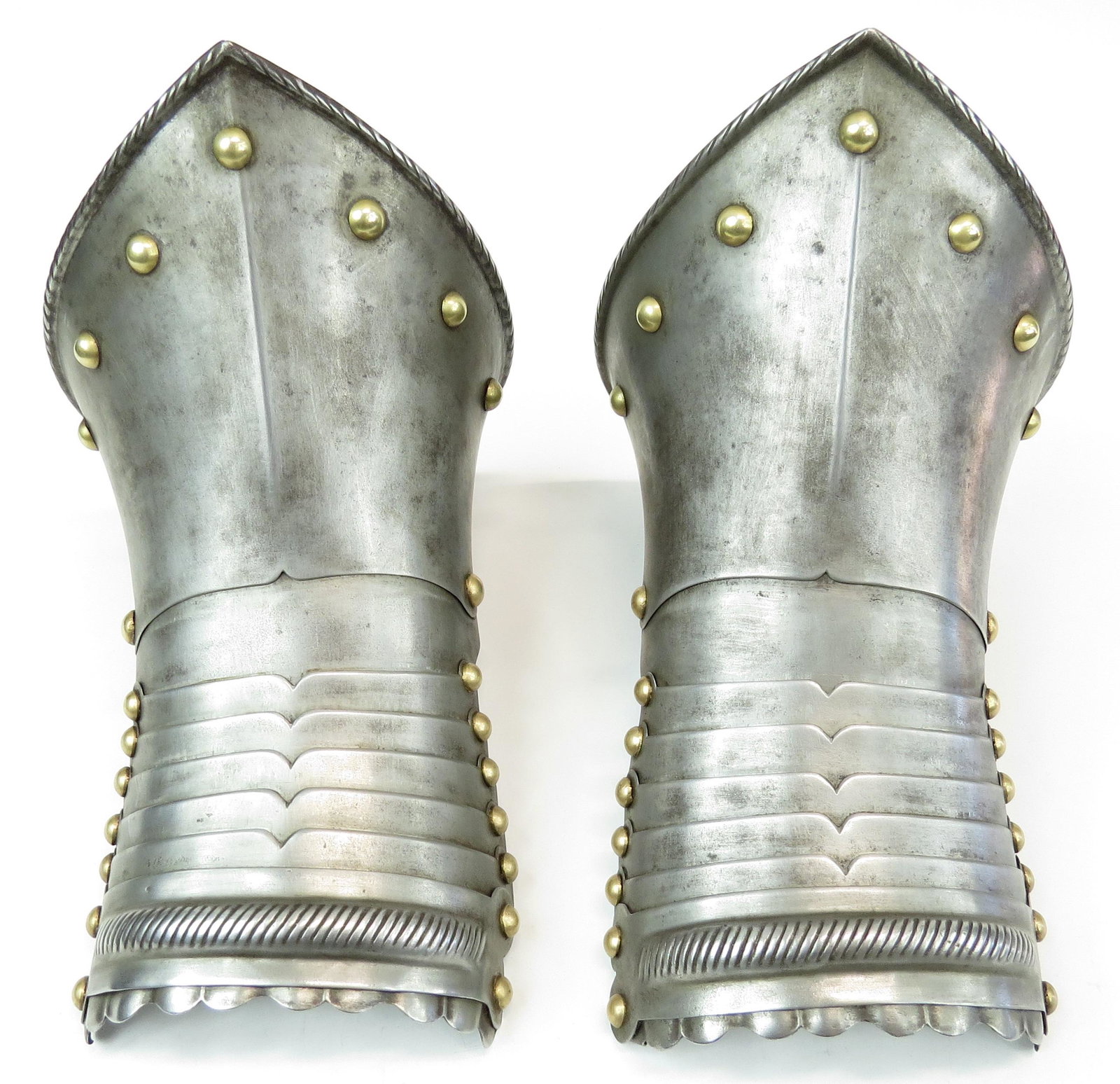 A PAIR OF EUROPEAN ARMOR GAUNTLETS: Very well wrought pieces of armor, likely German. The pointed cuffs with rolled and roped edges and brass studs. The backs of the hands well-articulated with profiled lamellae and brass studs, with ro
