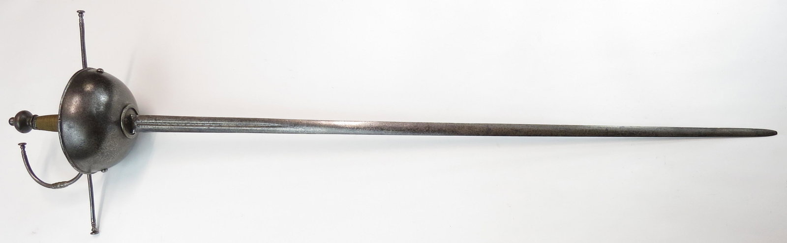 A RARE PORTUGUESE CUPHILT RAPIER: The deep cupguard with rolled border and fine foliate pierced guarda polvo, with robust knucklebow and guard with beaded terminals, the flattened spherical pommel en suite. Wooden grip retains its twi