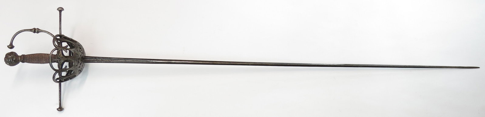 AN ITALIAN CUPHILT RAPIER: With elegant openwork guard engraved at the base with birds amongst foliage, the quillons and knucklebow terminating in large domed finials, the knucklebow double-beaded to the center, the pommel chis