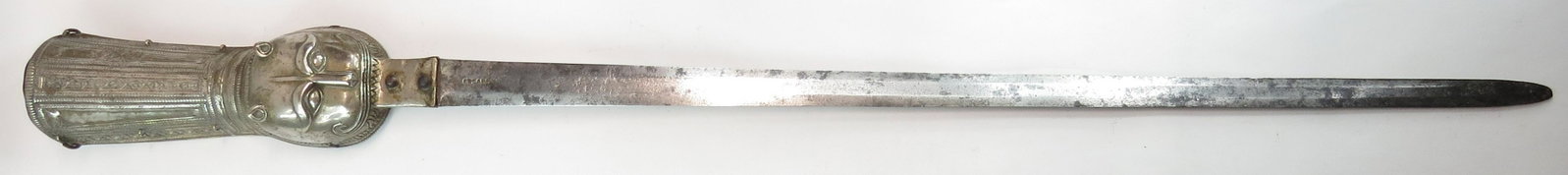 A FINE INDIAN PATA SWORD: An exceptional example, the hilt wrought in bronze, heavily silvered and finely embellished with rectangular panels of vinework with roped borders and a fully-modeled tigers head with ears, eyes, nose