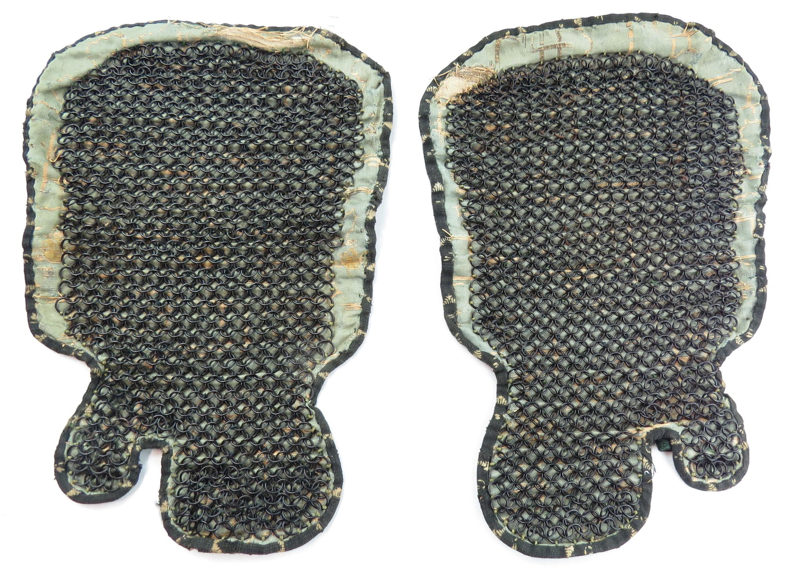 A PAIR OF JAPANESE KUSARI KATABIRA ARMOR GAUNTLES: A rare pair of Edo Period gauntlets wrought of mail on padded silk brocade with stamped leather borders. 18th-19th century. Brocade worn. Overall length 33cm. Condition III