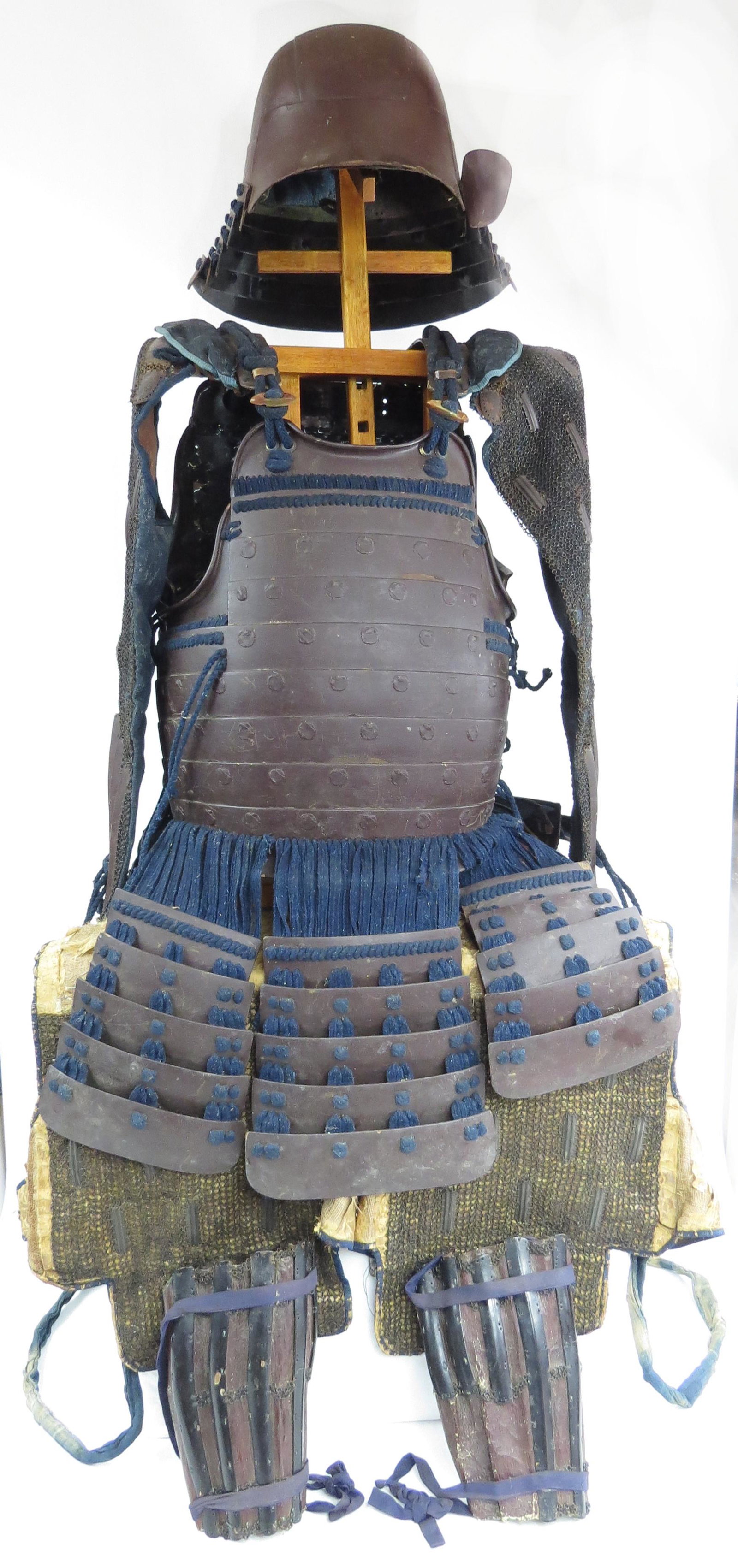 A SUIT OF JAPANSE SAMURAI ARMOR: Edo era, comprising a six-plate steel kabuto helmet and shikoro in dark brown lacquer. The do is steel, the sode combined of mail and plates, the kusazuri likewise of steel. The haidate are composed o