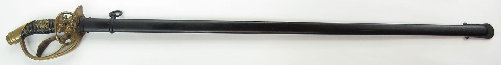 A PRUSSIAN M 1889 INFANTRY OFFICER'S SWORD DEGEN: With brass hilt and black-lacquered grip set with Kaiser Wilhelm II monogram, grip wires intact. Double-fullered straight blade of grosse Degen type. Scabbard intact. Late 19th century. Scabbard repai
