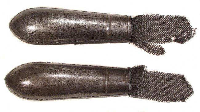 A RARE PAIR OF INDIAN ARMOR ARMGUARDS: Wrought entirely of steel with raised oval panels at the wrist, and lavishly inlaid overall with floral sprays in silver, including the applied, profiled borders. The hinged wrist plates with pin clos