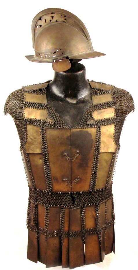 A Suit of Moro Armor: Comprising a very rare helmet and plate and mail coat, the helmet of classic form showing European influence throughout with domed skull and pronounced comb with pierced scrollwork, peak and neckguard