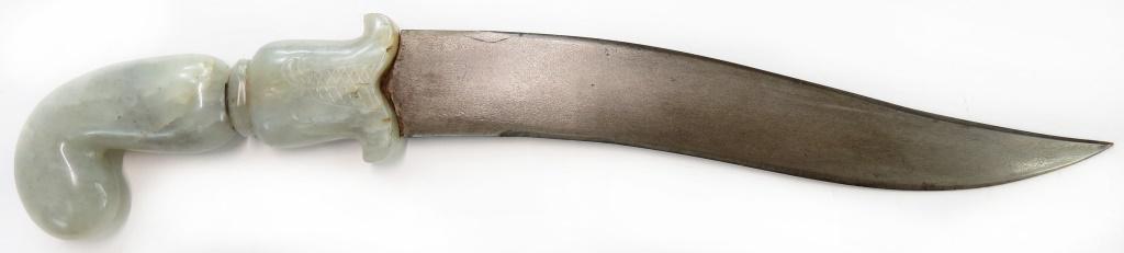 AN INDIAN KHANJAR DAGGER: Mughal work, with jade grip, the recurved, double-edged blade wrought of crystalling wootz. 19th century. Overall length 31cm. Condition II