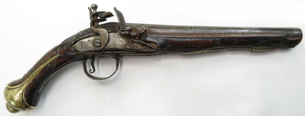 A CONTINENTAL FLINTLOCK PISTOL: Italian work with stepped barrel replete with marks and well-made flintlock mechanism. Brass furniture. 18th century. Well worn, minor losses to stock. Overall length 37cm. Condition III