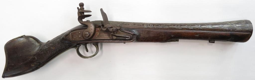 AN OTTOMAN FLINTLOCK BLUNDERBUSS: The hardwood stock of characteristic form, with brass buttplate, counterplate and triggerguard, with a silver escutcheon depicting a fouled anchor. With flintlock mechanism, the massive barrel with fl