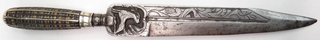 A MEDITERRANEAN DAGGER: Catalonian or Neapolitan work, the grip of delicately-fluted horn and brass sections retained by silver bands, with solver pommel and ferrule. The broad, straight, single-edged blade with well-chisele