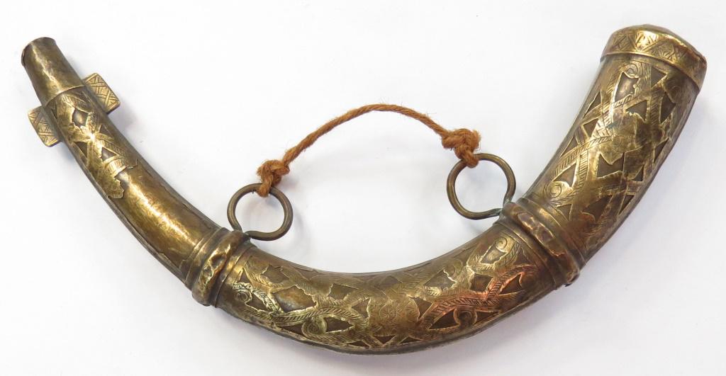 A MOROCCAN POWDERHORN: Of typical form with pierced body. 20th century. Overall length 28.5cm.Condition III