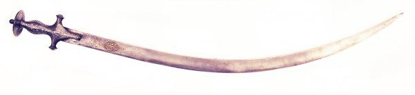 A MUGHAL SABER SHAMSHIR: The iron hilt elaborate inlaid in silver overall, the curved, singled-edged blade struck at the forte with a maker's mark and finely chiseled with a gold-inlaid cartouche containing Quranic verse 61:1