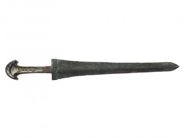 A BRONZE AGE SWORD: Of straight, double-edged for with obtuse point characteristic of the Luristan culture of west central Iran. Silhouette tang with flared pommel would originally have been fitted with organic grip mate