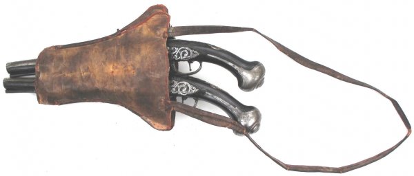 A PAIR OF OTTOMAN FLINTLOCK KUBUR PISTOLS: Of impressive dimensions, the hardwood stocks with relief carving to breach and forearm, bordered iron furniture and profiled and engraved silver escutcheons, the locks with all elements scrolled, eng