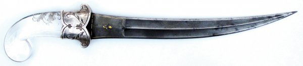 A MUGHAL ROCK CRYSTAL-HILTED DAGGER KHANJAR: Of classic form and considerable size, the rock crystal grip with rolled pommel with carved vegetal motif, the guard of silver engraved en suite. The lightly curved, double-edged silver-gray wootz dam