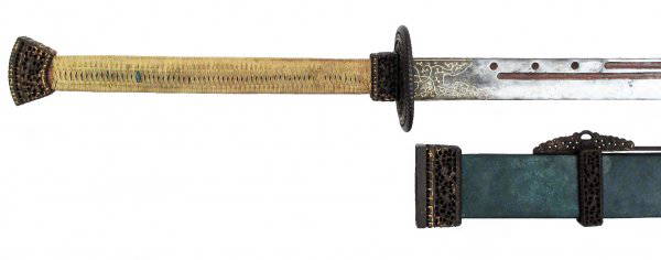 A CHINESE TWO-HANDED SABER SHUANG SHOU DAO: A rare early Qing Dynasty saber, made to order for an officer. The exceptionally long wooden grip lined with polished green rayskin and retaining its original green cord wrap. The mounts are of 